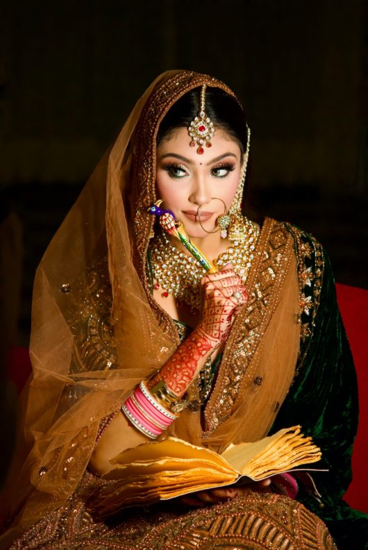 Traditional bridal makeup look in a golden veil