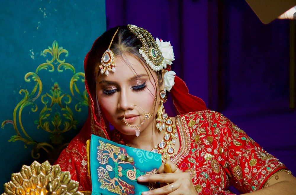 Red lehenga bridal makeup with floral hair styling